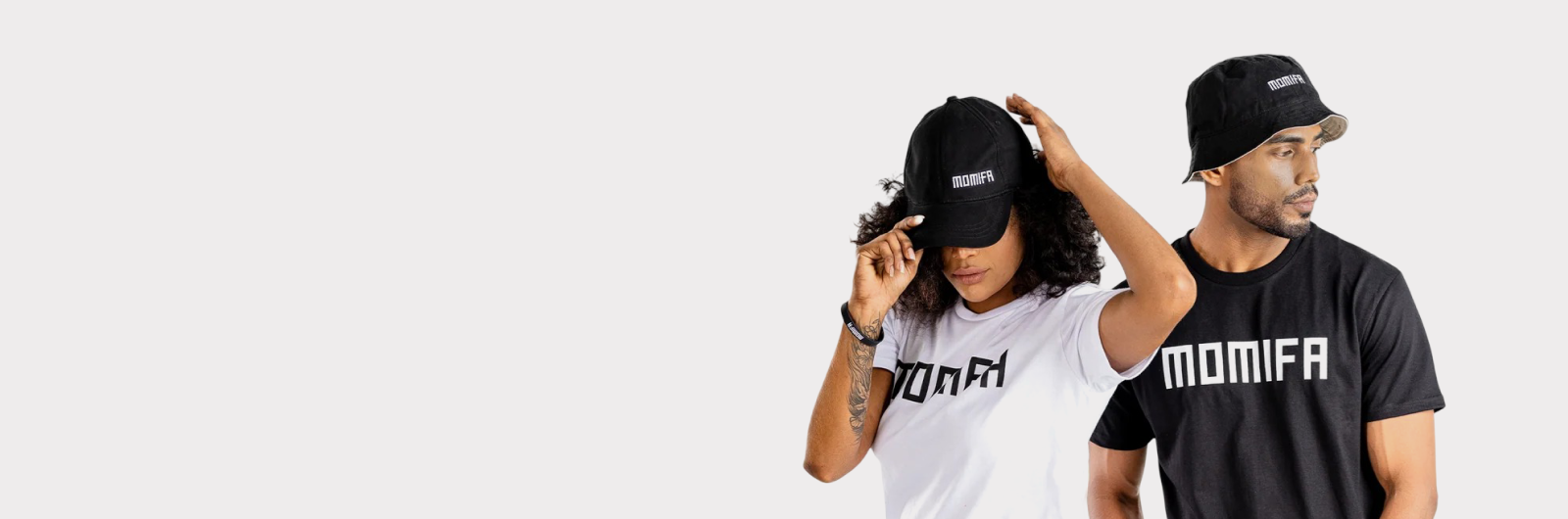 man and woman pose together, wearing t-shirts that say "MOMIFA".