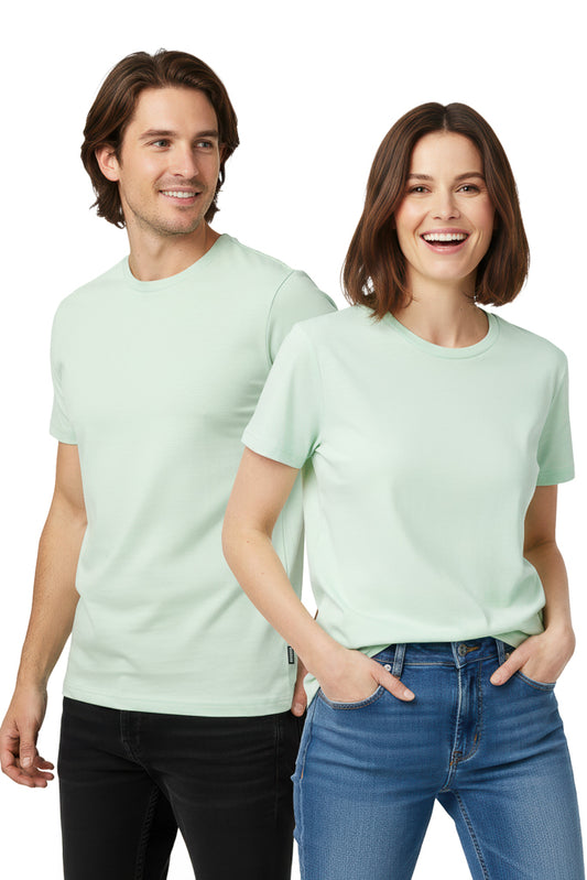 Man and a woman stand side-by-side, both wearing matching light green t-shirts and jeans.