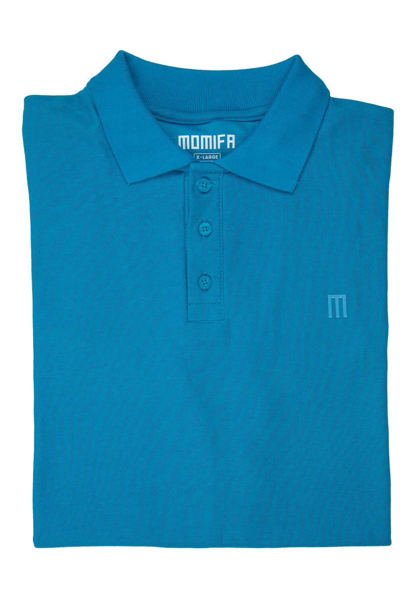Blue polo shirt with a collar, a three-button placket, and a small tag that says ""MOMIFA X-LARGE"" on the collar area.