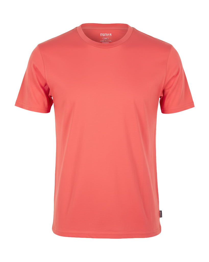 Plain coral-colored, short-sleeve men's t-shirt. It has a crew neck and a small black tag on the lower-left hem.
