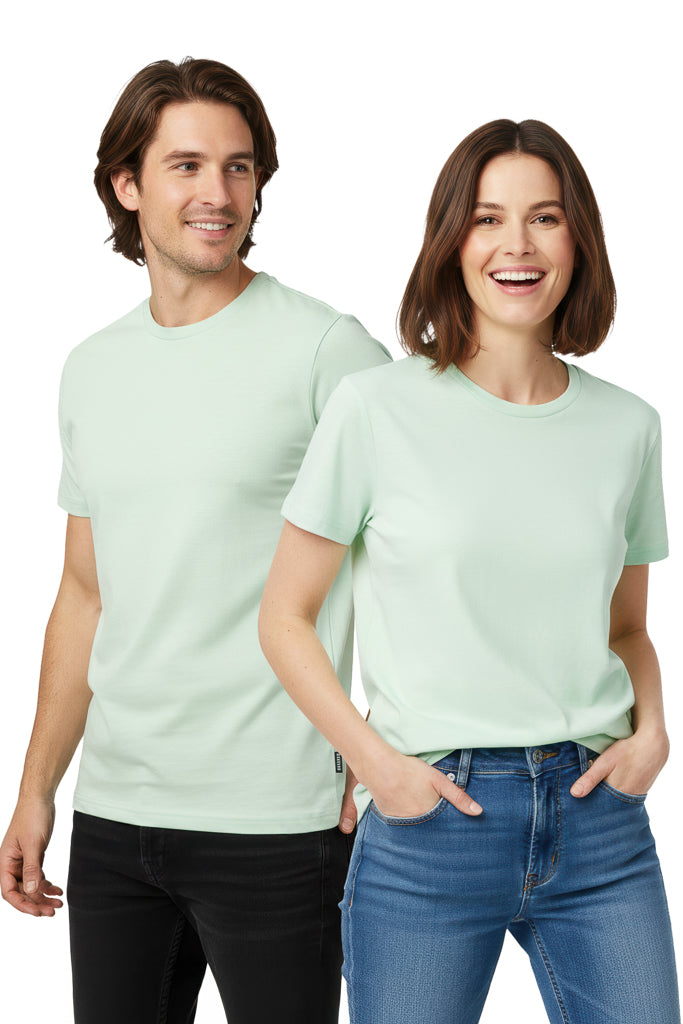 Man and a woman stand side-by-side, both wearing matching light green t-shirts and jeans.