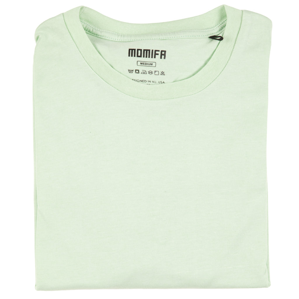 Light green Momifa brand medium-sized t-shirt with a visible tag. The shirt is plain with a round neck.