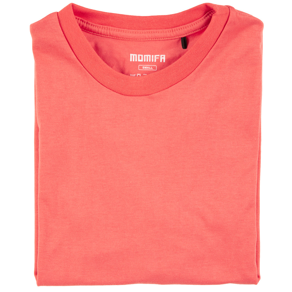 Neatly folded, reddish-orange t-shirt with a small "MOMIFR" brand label at the collar, on a white background.