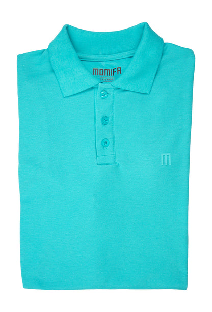 Folded turquoise polo shirt with a collar, a three-button placket, and a tonal "M" logo embroidered on the left chest.
