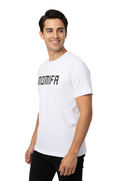Smiling young man with dark hair, wearing a white t-shirt with the MOMIFA logo.
